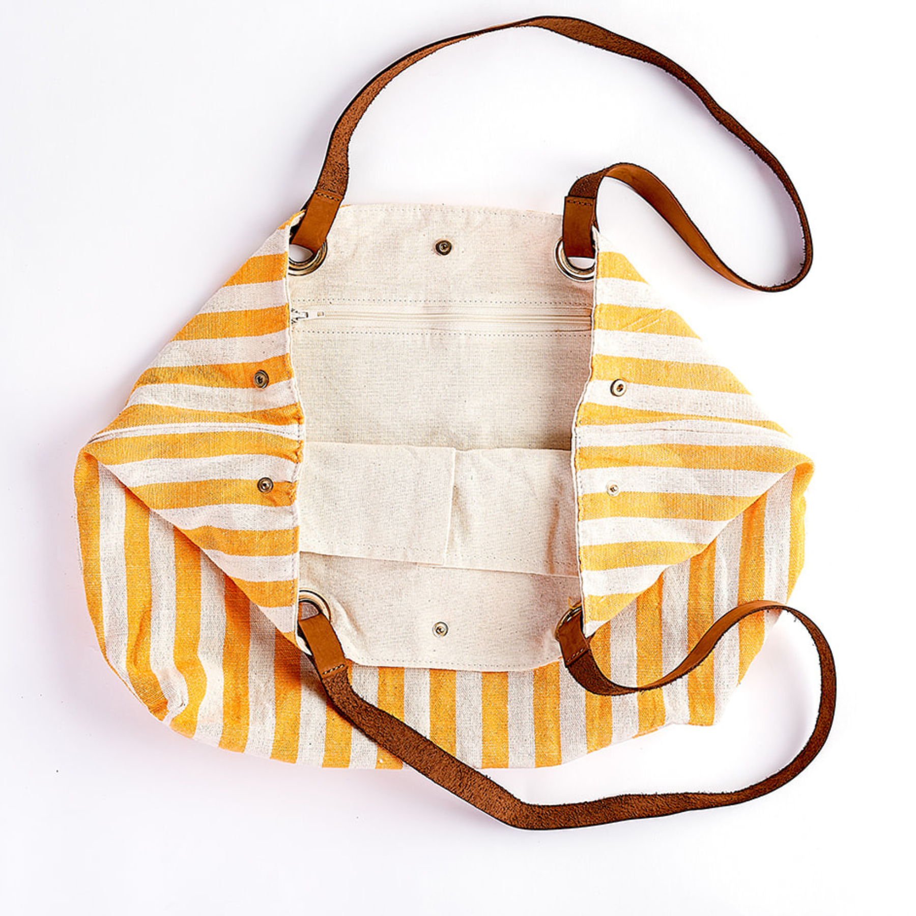 A striped canvas shoulder bag with yellow and white vertical stripes, brown leather straps, and silver metal hardware, shown on a plain white background.