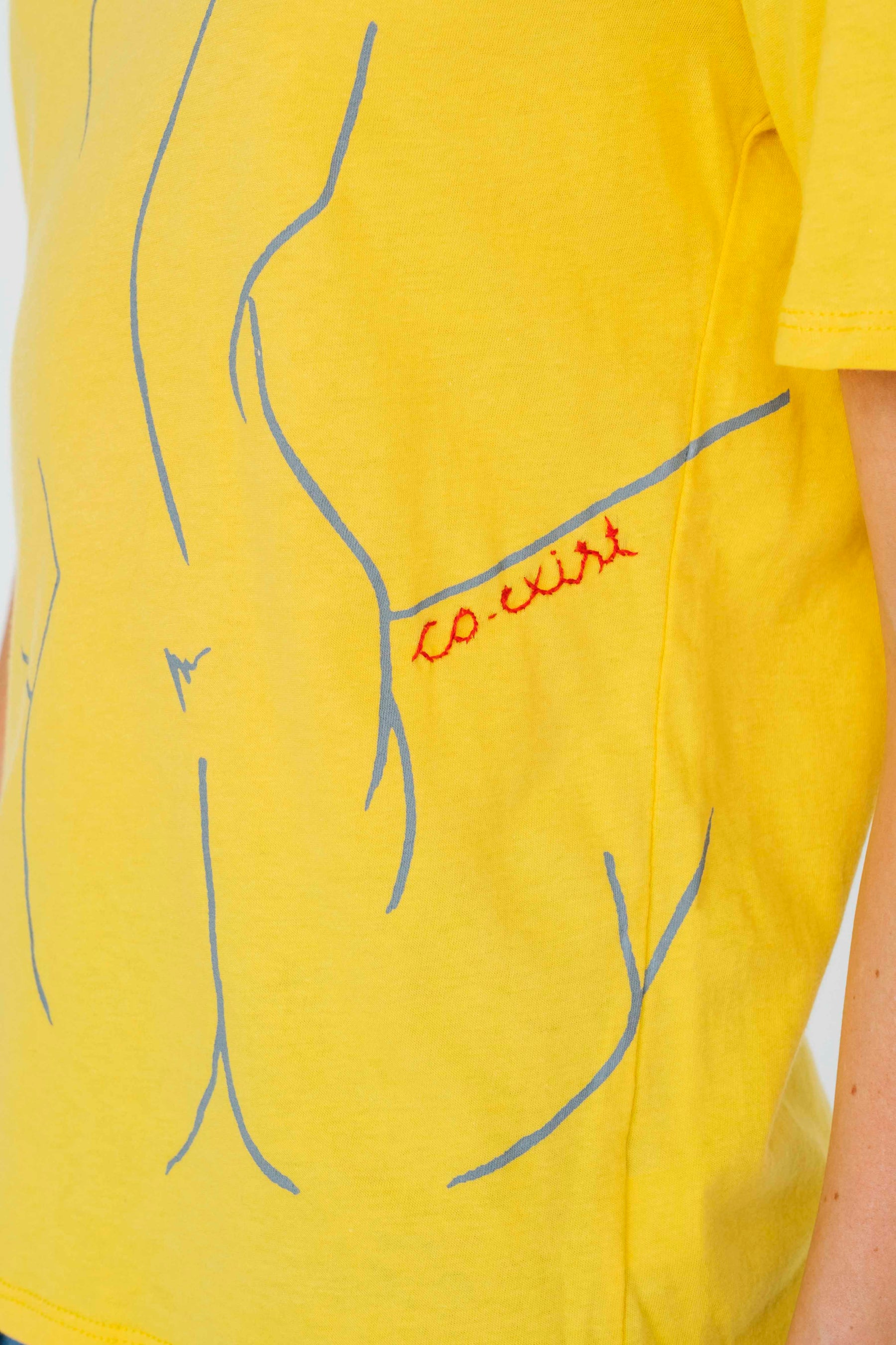 Co-Exist Tee in Yellow flat lay with minimalist styling