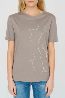Model wearing Co-Exist Tee in Taupe with hand embroidery